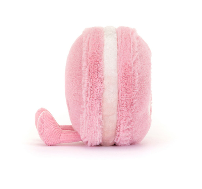 Pink plush toy shaped like a macaron on a white background