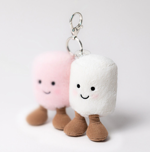 Two plush keychains shaped like marshmallows with smiling faces on a white background