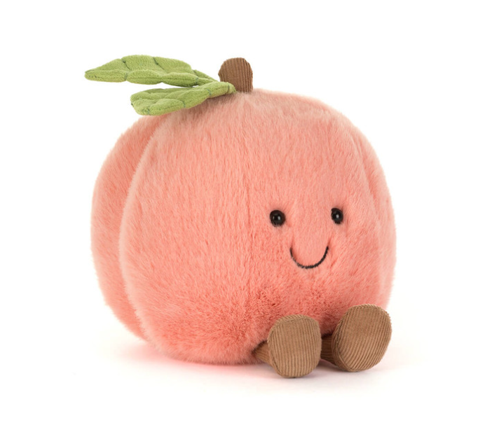 Plush toy peach with a smiling face on a white background