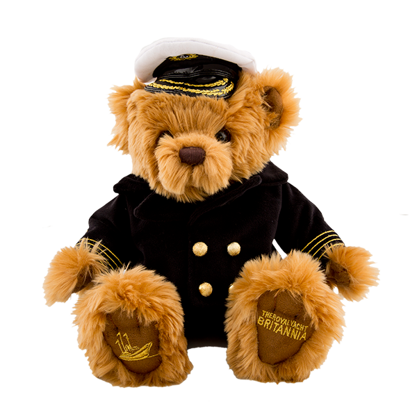 Stuffed teddy bear in a captain's outfit with a hat on a white background